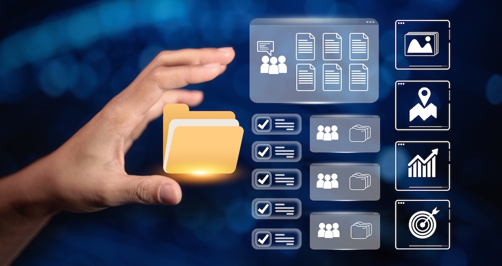 A hand grabs for a folder, to illustrate how building a robust knowledge base helps lead to success